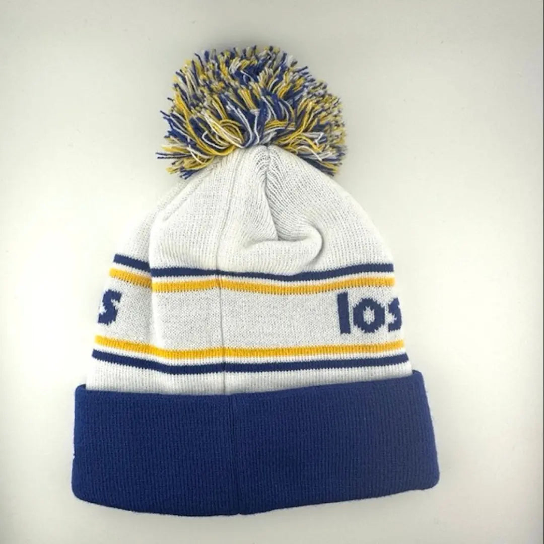 White knit cap with yellow/blue stripes around blue team name, Rams logo in center of blue cuff & yellow/blue/white pom atop