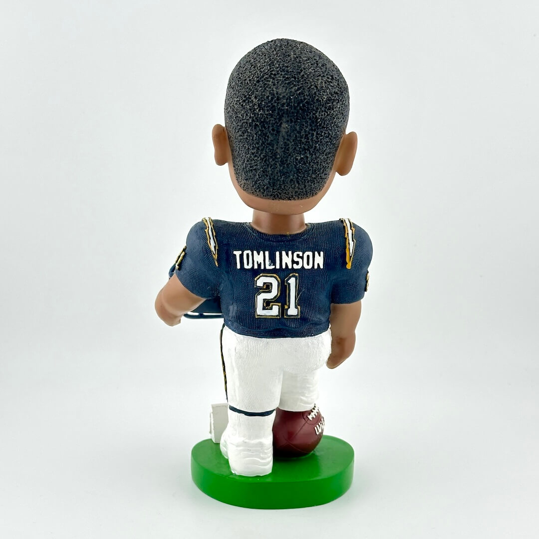 Bobblehead figure of a football player in a blue jersey with 'Tomlinson 21' on a white background