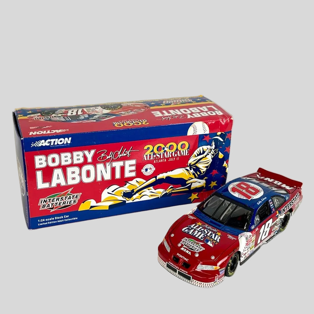 A diecast race car next to its original packaging box, and is red and blue with 'BOBBY LABONTE 2000 ALL-STAR GAME' 