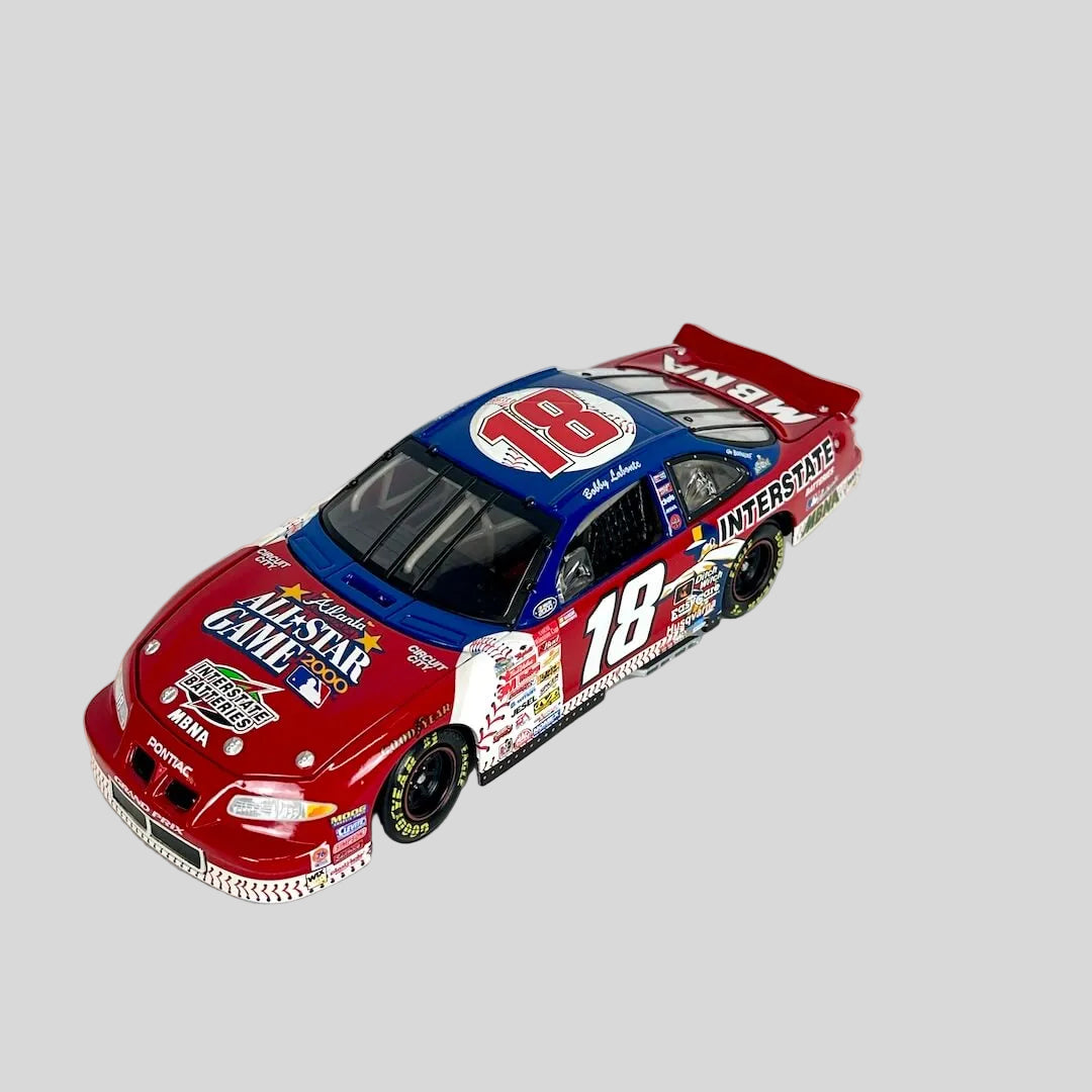 A die-cast model of a red and blue 18 Interstate Batteries race car with All-Star Game branding. 