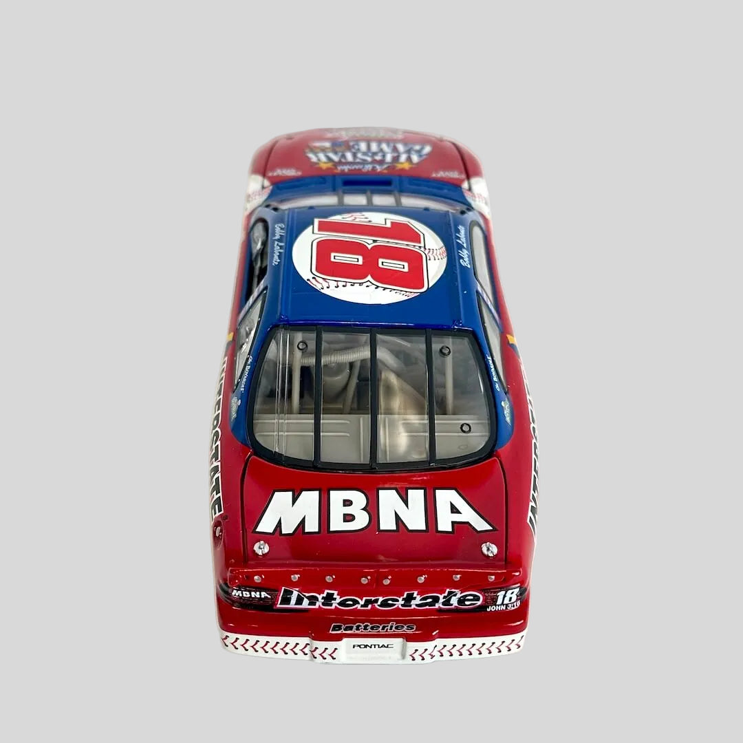 A diecast model race car viewed from the rear, featuring a red and blue livery with 'MBNA' branding.