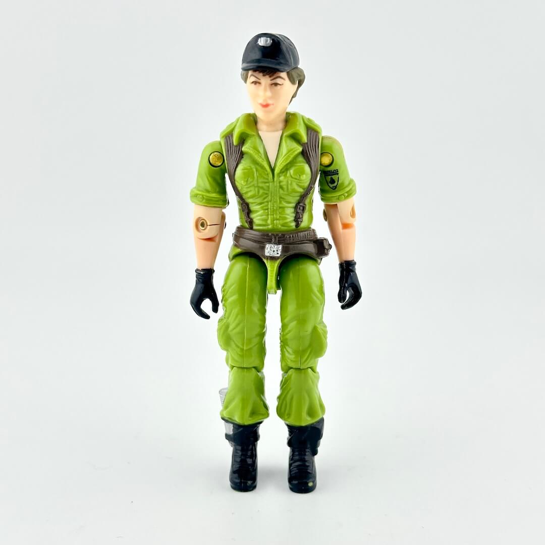 Female GI Joe action figure in green military uniform with brown and black accents, pictured on white background. 