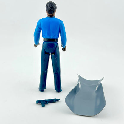 Action figure in blue outfit with cape and weapon on white background. 
