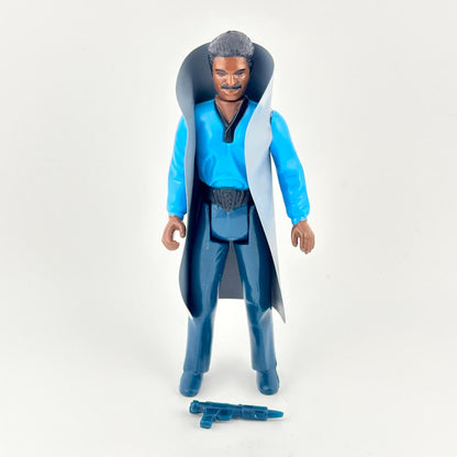 Action figure wearing a blue robe and dark pants, with a blue weapon on white background. 