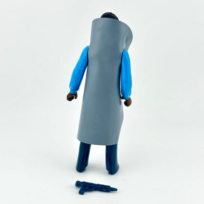 A toy action figure shown from the back, wearing a long gray coat over bright blue sleeves and dark blue pants.