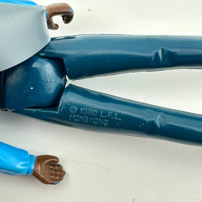 Close-up of a vintage plastic action figure leg joint, showing the blue painted plastic with a molded '© 1980 L.F.