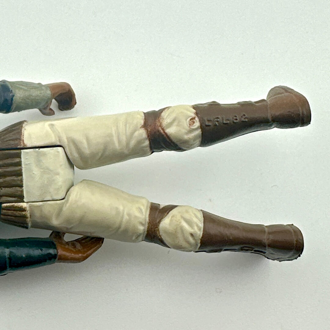 Close-up of a toy figure's legs with COO and copyright information. 