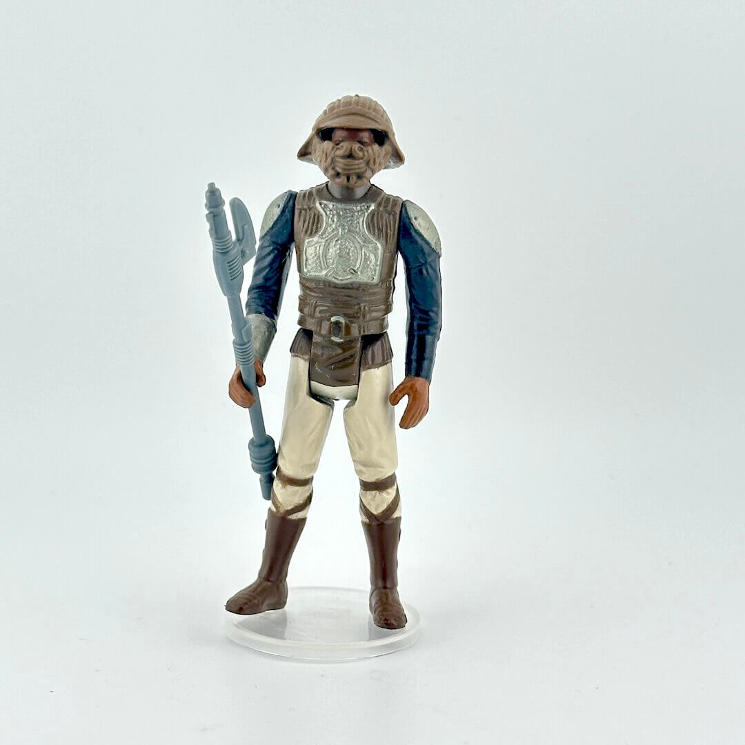 Action figure of Lando in Skiff Guard outfit from Star Wars franchise on a white background