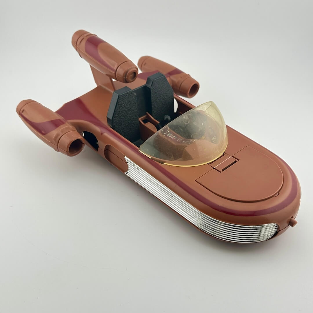 Toy model of a spaceship with a brown and red color scheme on a white background
