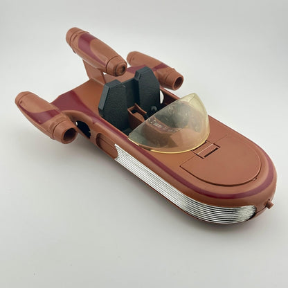 Toy model of a spaceship with a brown and red color scheme on a white background