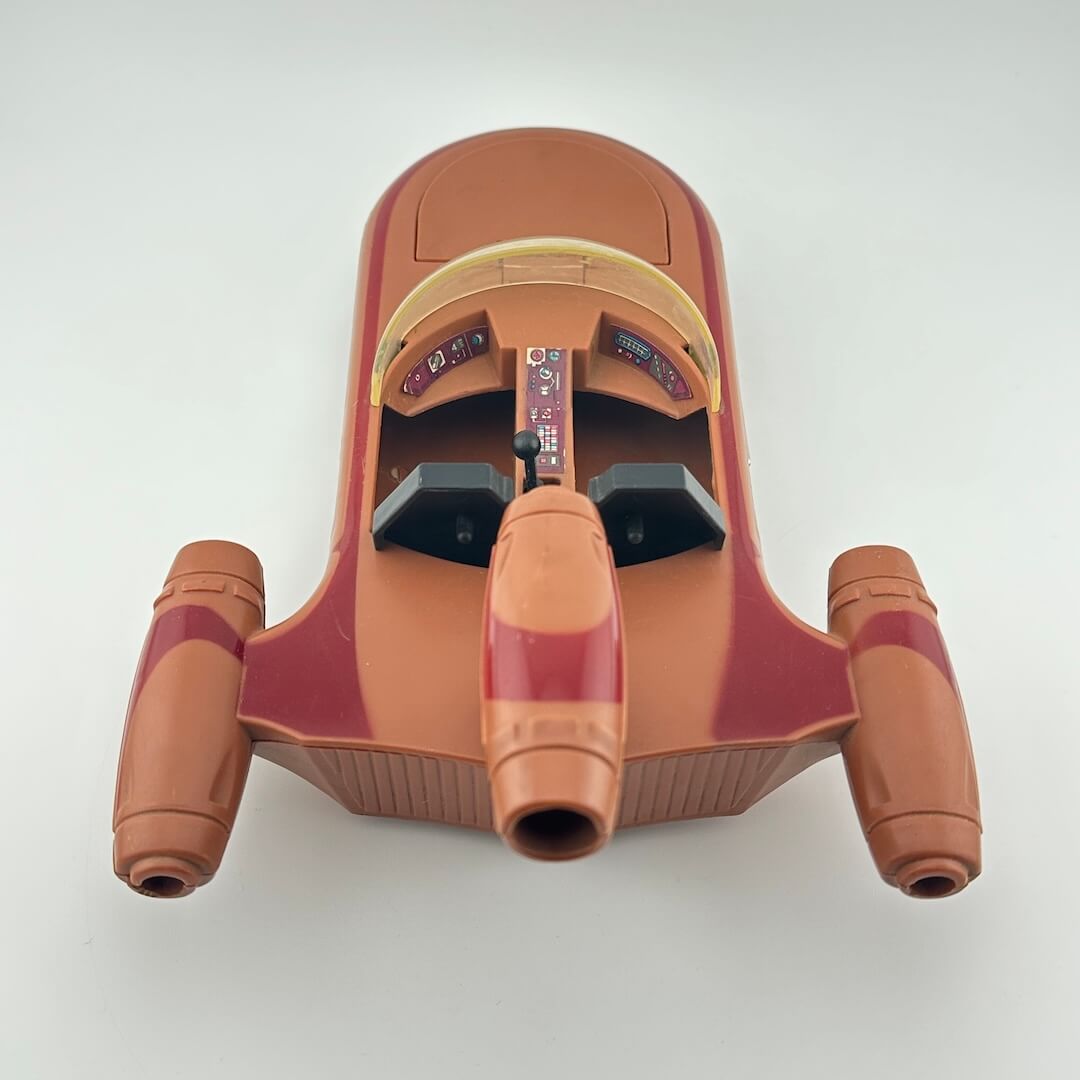 Top view of a toy spaceship model on a white background