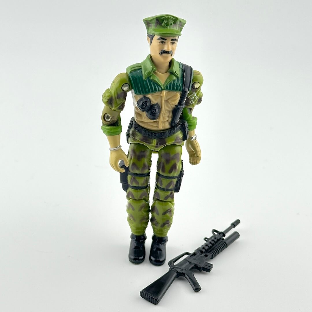 Toy figure in green military uniform with rifle on a white background