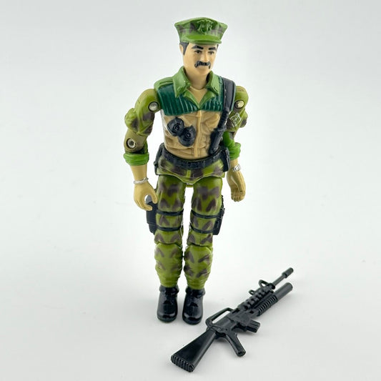 Toy figure in green military uniform with rifle on a white background