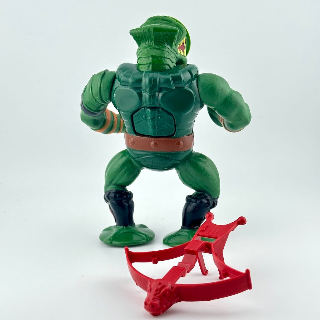 Green action figure with suction cups for hands pictured with red crossbow against white background.