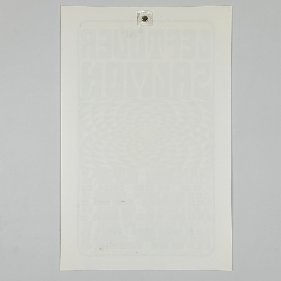 Backside of white poster against white background. 