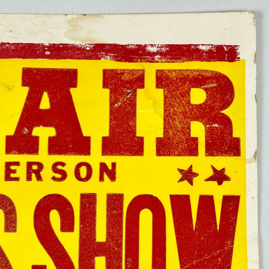 Top right corner of poster with some water and edge damage. 