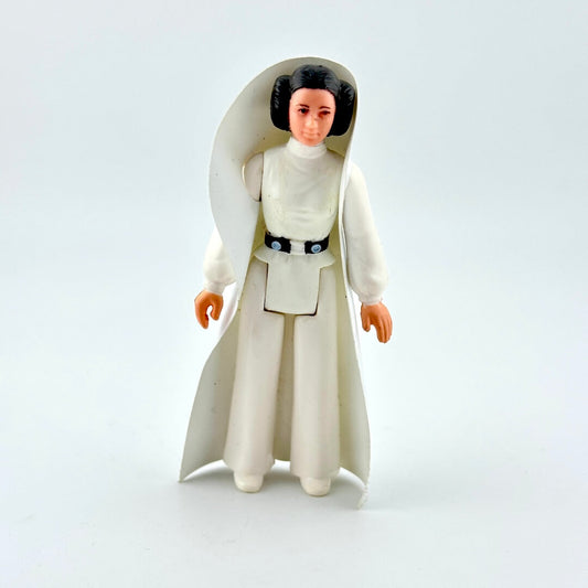 Action figure of a character in a white outfit with a hood on a light gray background