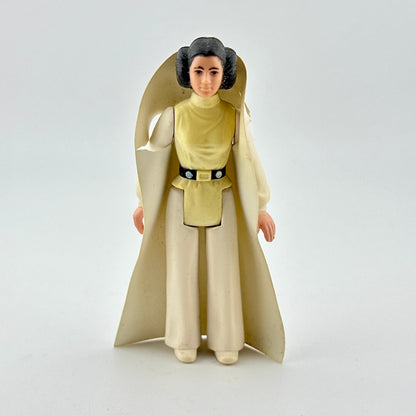 Toy figure of a character in a long beige robe on a white background