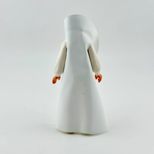 Action figure in white cloak against white background. 