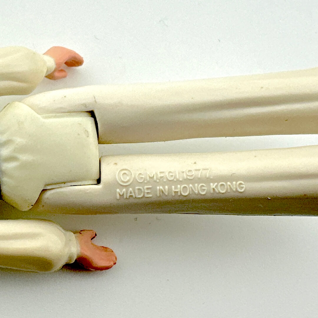 Toy figure with 'Made in Hong Kong' stamp on a white background