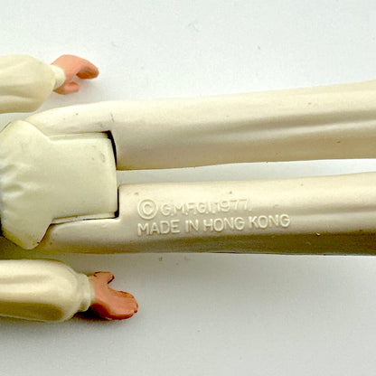 Toy figure with 'Made in Hong Kong' stamp on a white background
