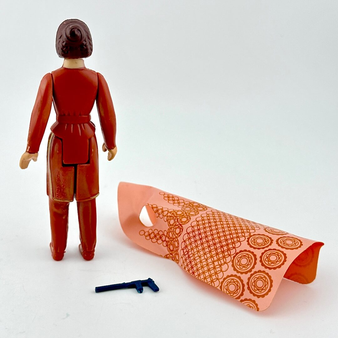 Action figure with a piece of clothing and weapon on a white background