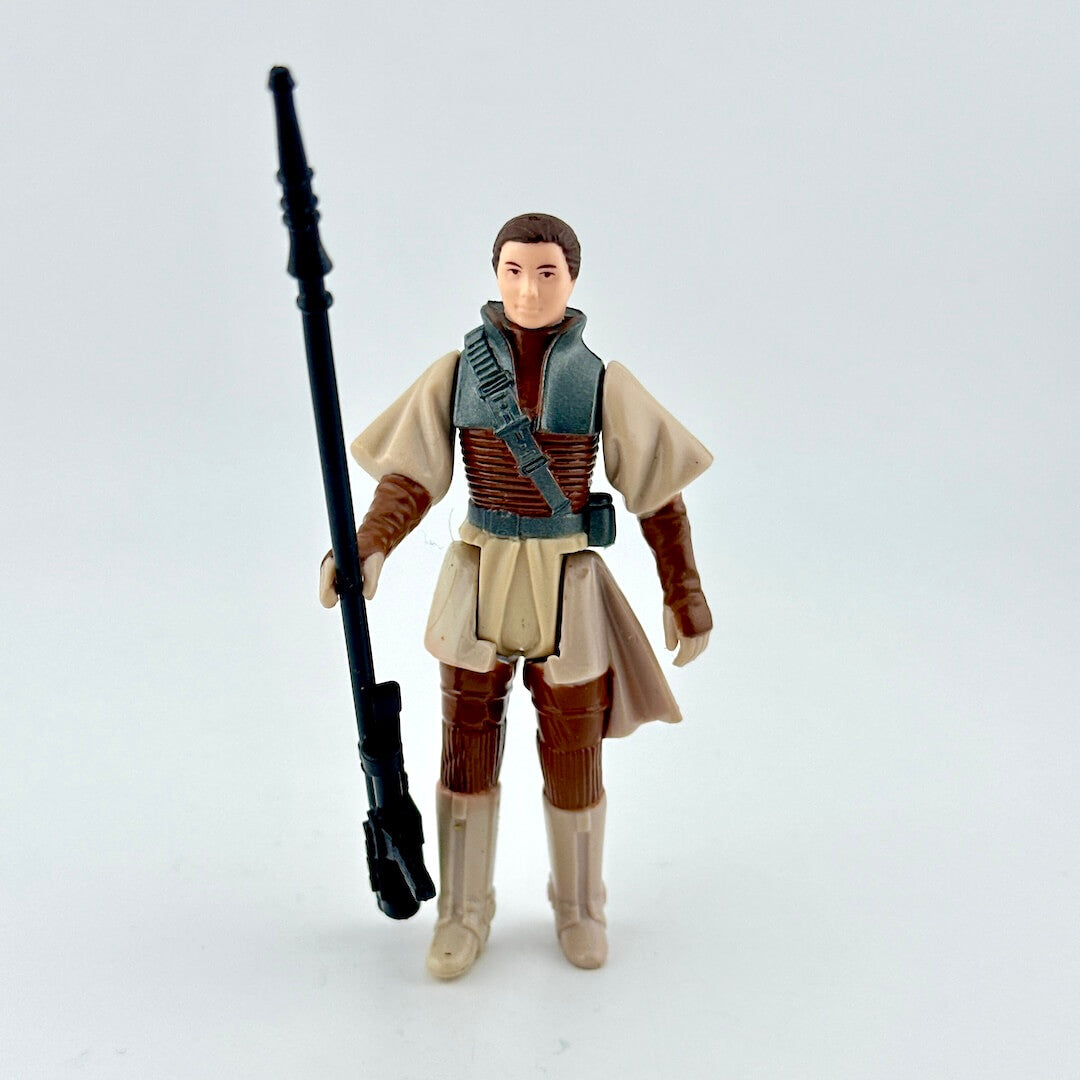 Action figure in a costume holding a weapon on a light gray background