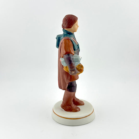 Star Wars figurine with red tag against white background. 