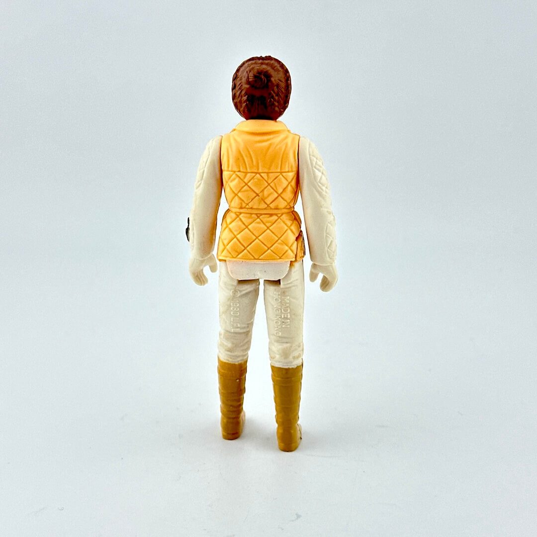 Action figure with a yellow vest and brown boots on a white background