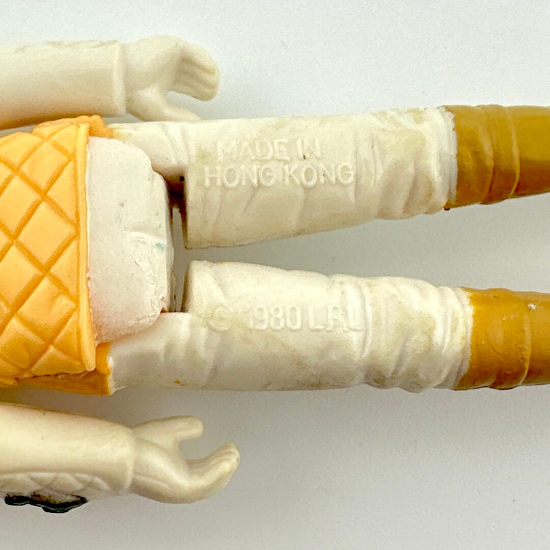 Close-up of back of figure's legs to show copyright and COO information. 