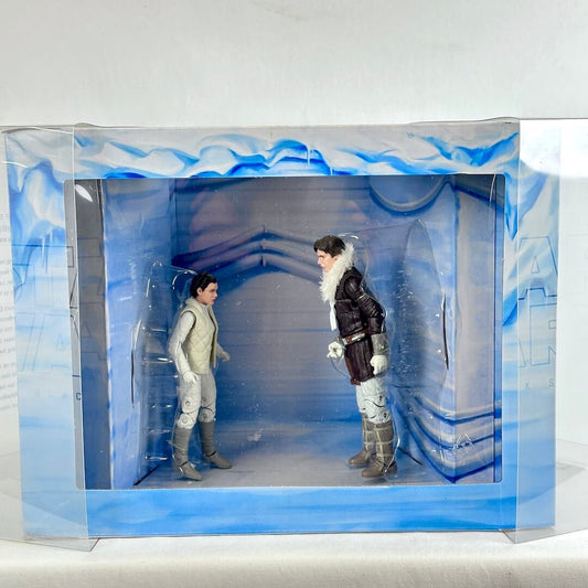 A boxed collectible action figure set showing two small humans posed inside a blue icy-themed display window box.