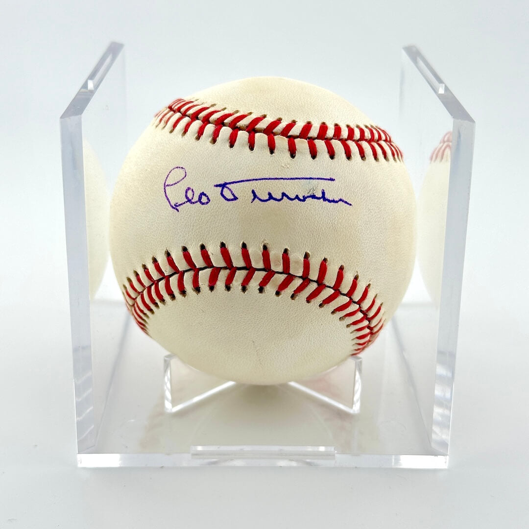 Signed baseball in clear display cube against white background. 