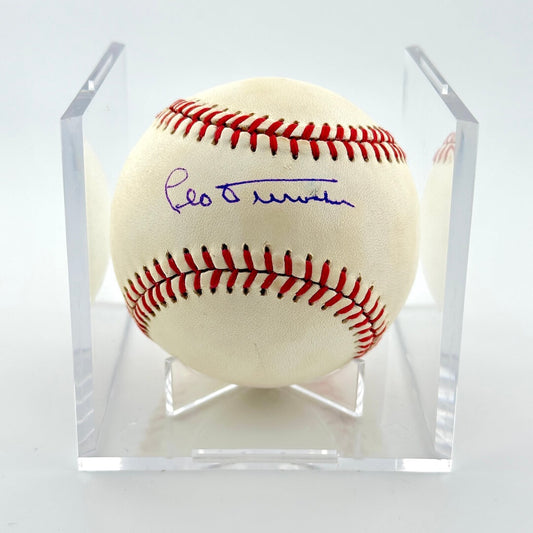 Signed baseball in clear display cube against white background. 