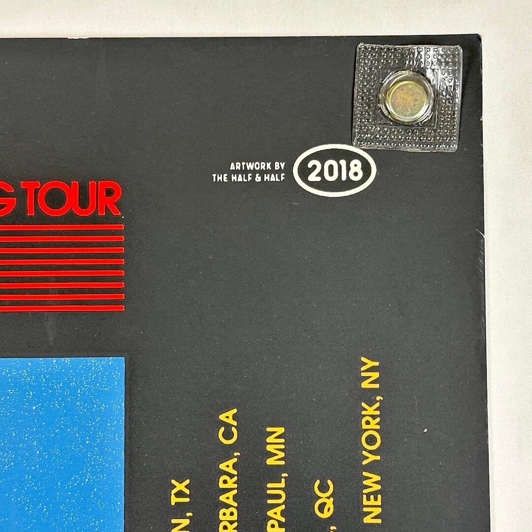 Black album cover with red text, yellow text, and a silver label on a white background