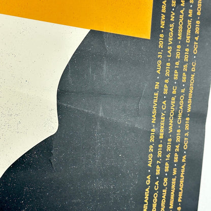 Promotional poster with silhouette of a person and tour dates listed on a textured background