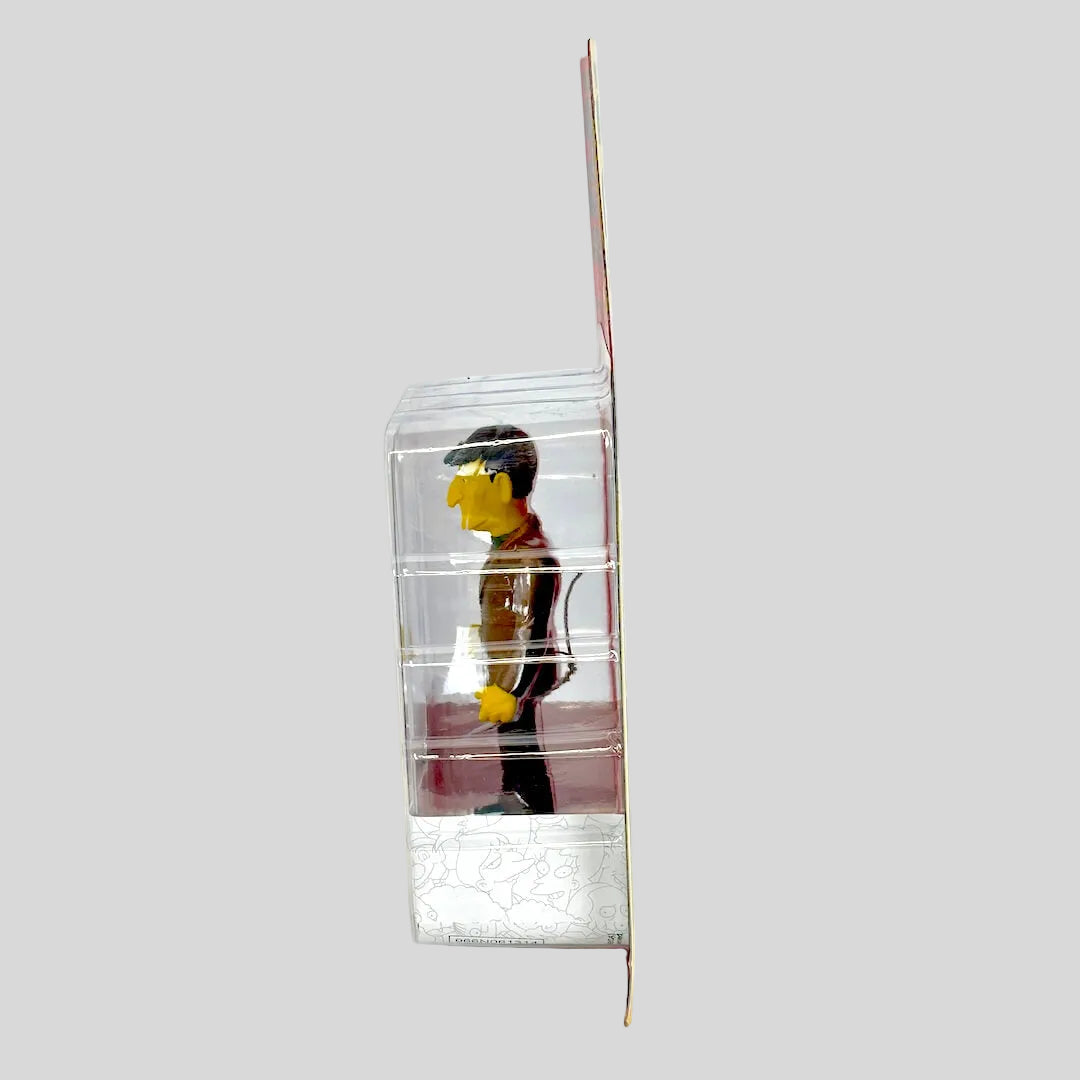 Clear plastic packaging with a small figure inside on a white background