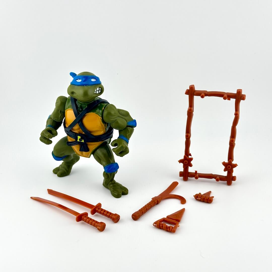 Teenage Mutant Ninja Turtle with accessories on white background. 