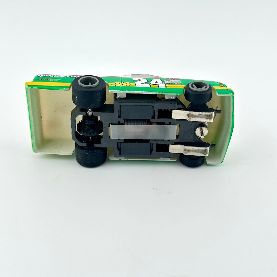 Toy car with a green and yellow body on a white background