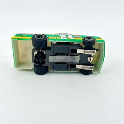 Toy car with a green and yellow body on a white background