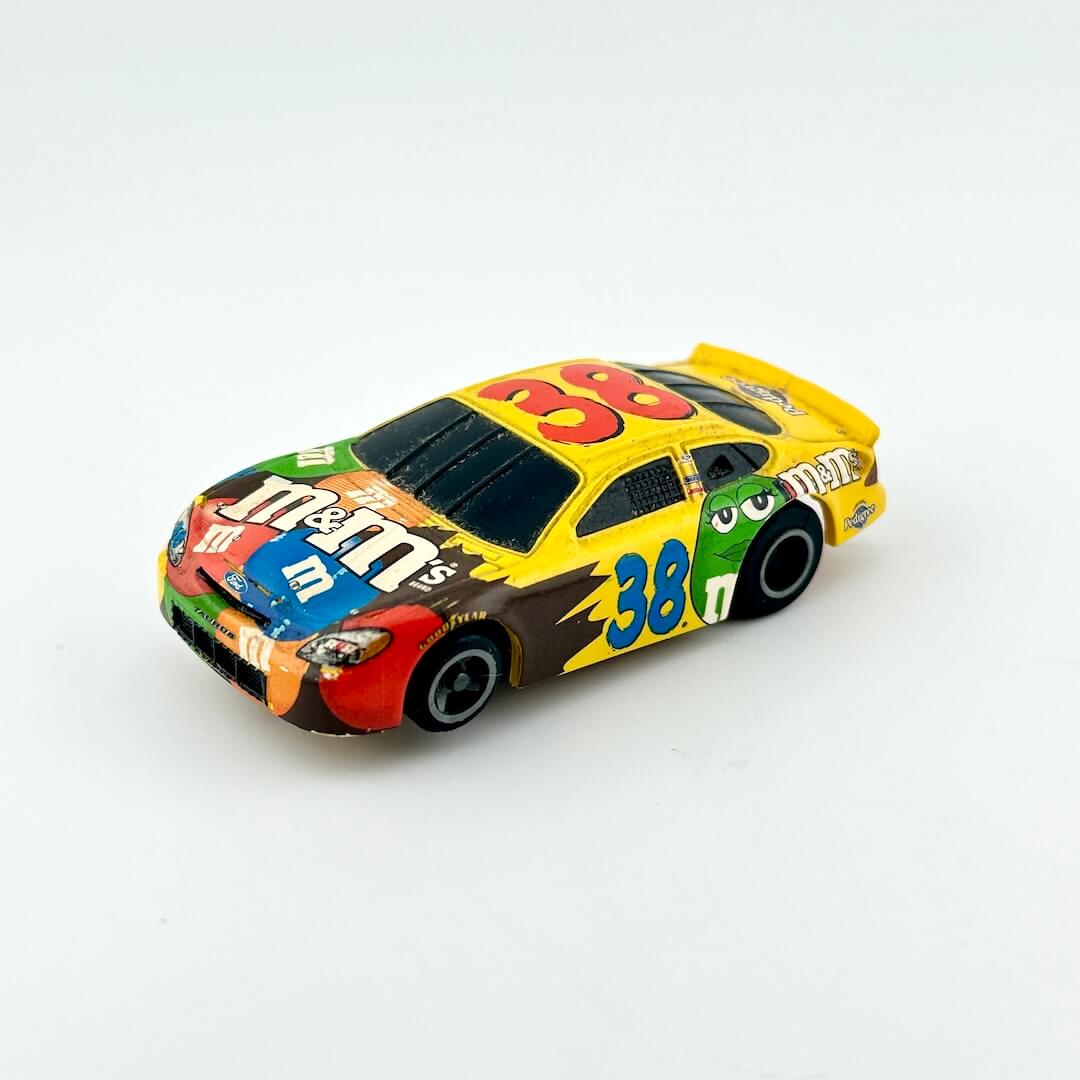 Colorful toy race car with M&M's branding on a white background