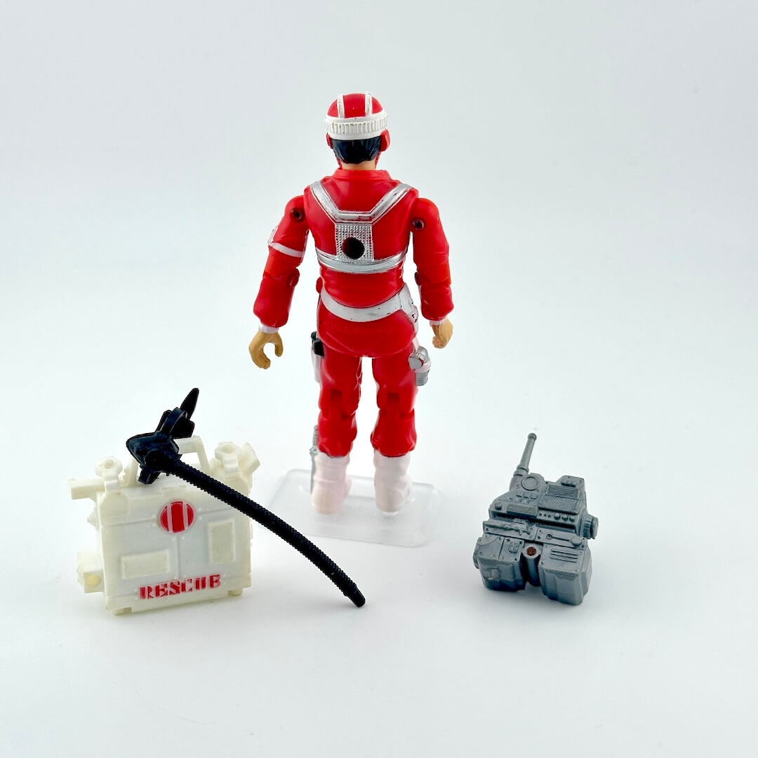 Toy figure in a red uniform with helmet, tools, and a 'Rescue' box on a white background