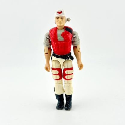 GI Joe action figure in beige pants with red vest and white helmet, photographed on white background. 