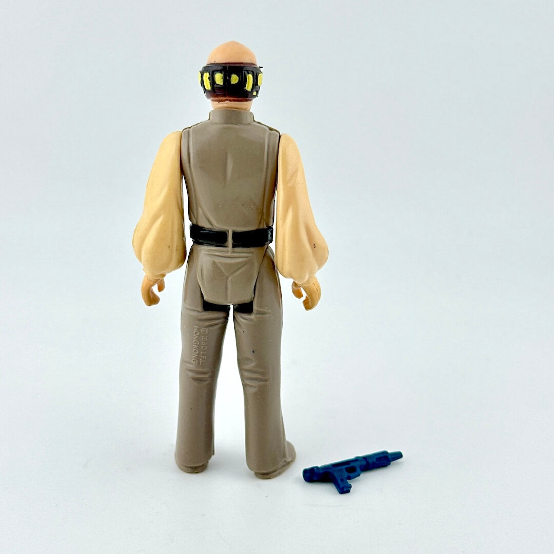 Action figure in brown suit with weapon on white background. 