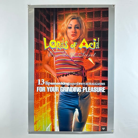 Poster for 'Lords of Acid' with a woman in a striped shirt and jeans on a brick wall background.