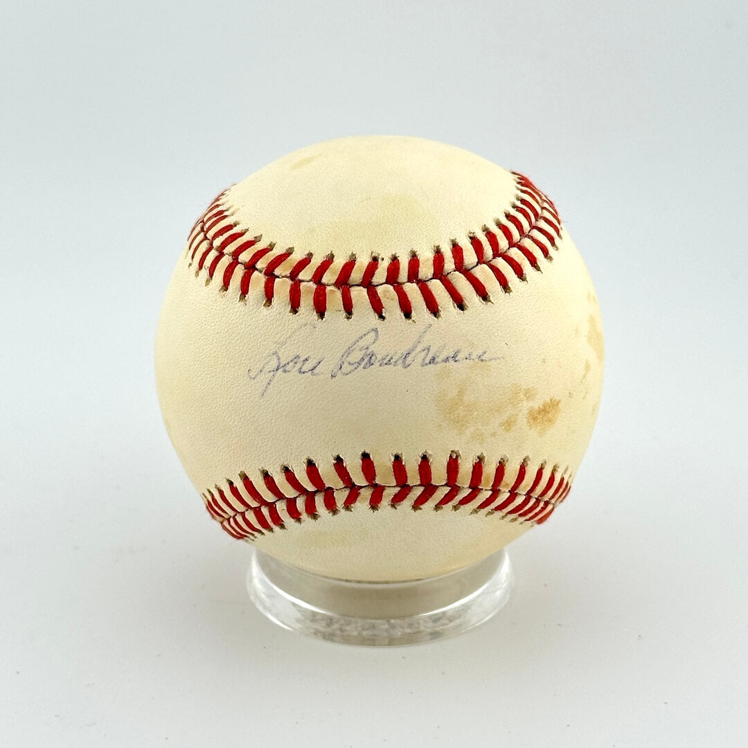 Baseball with red stitching on a white background