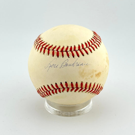 Baseball with red stitching on a white background