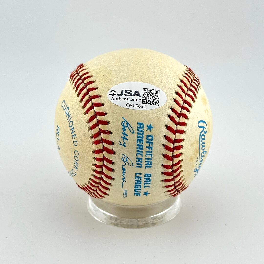 Baseball with JSA authentication label on a white background