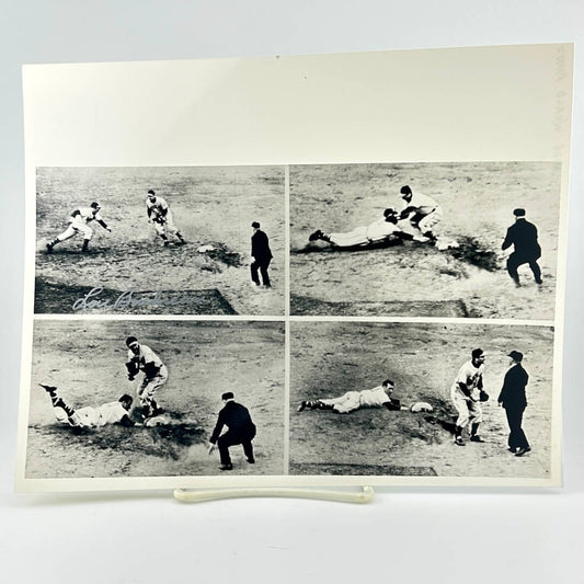 Vintage black and white photo of a baseball game with multiple players on the field.
