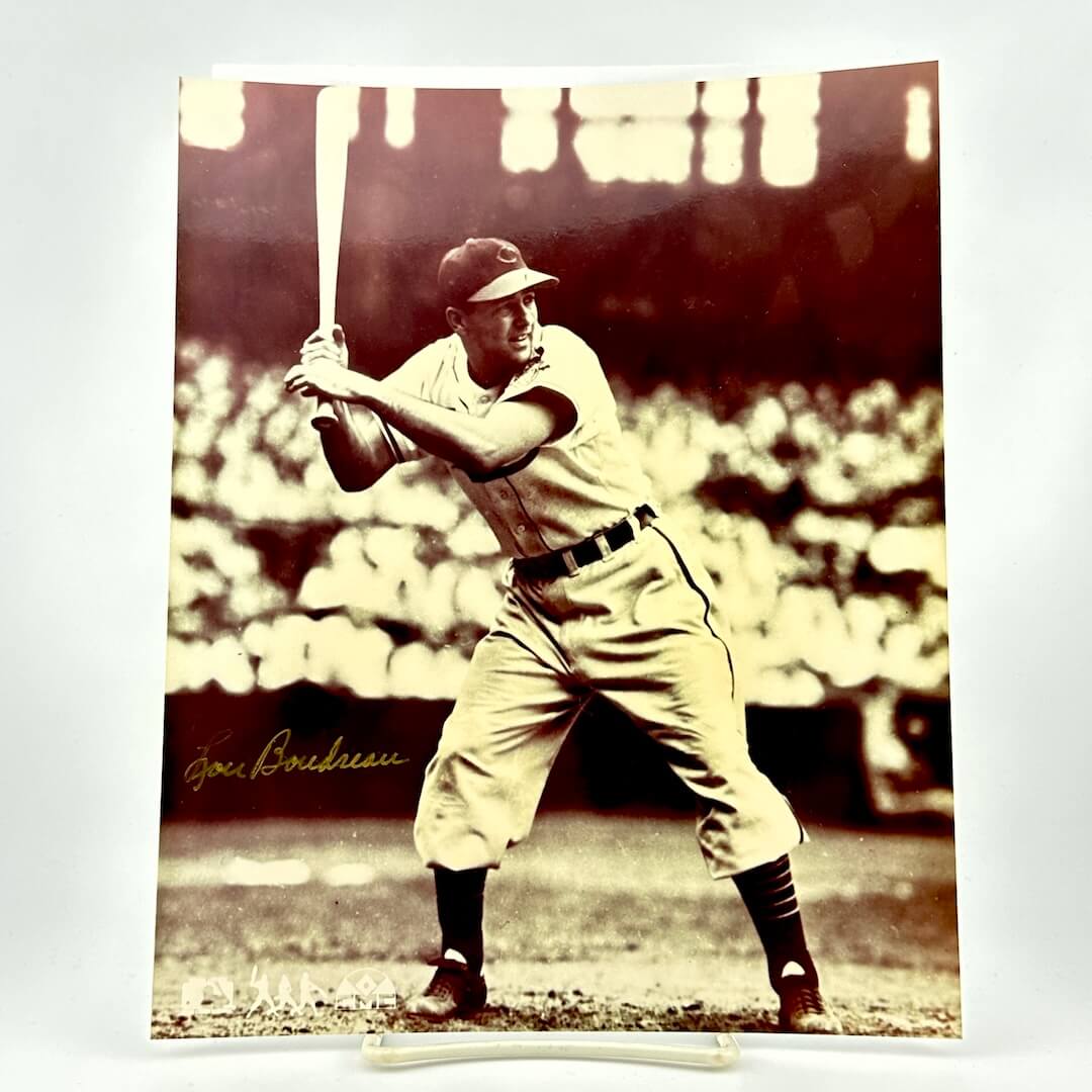 Vintage black and white photo of a baseball player in action with a bat, on a light gray background.