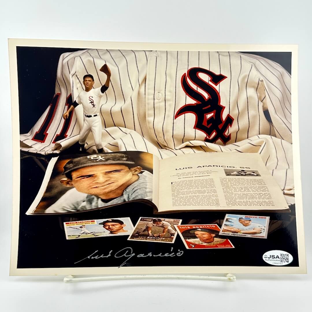Baseball memorabilia display with a jersey, photos, and cards featuring a player's signature.